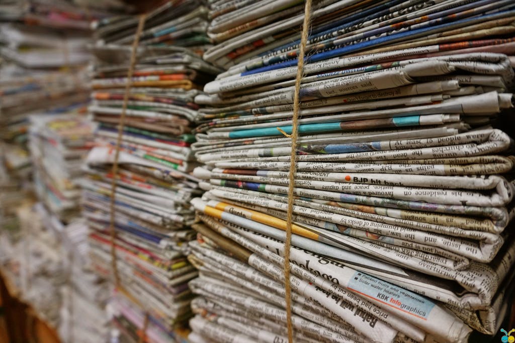 Close-up view of stacked newspapers tied with twine